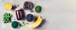 Banner of ingredients for heavy metals detox smoothie. Bilberry, barley grass, spirulina, orange
